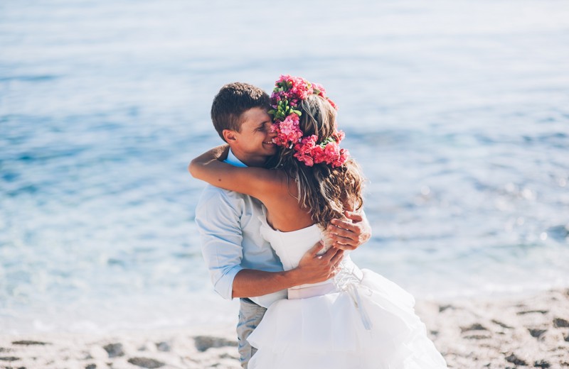 Bride and Groom hugging on the beach